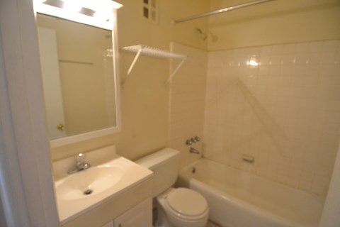 a small bathroom with a sink toilet and shower